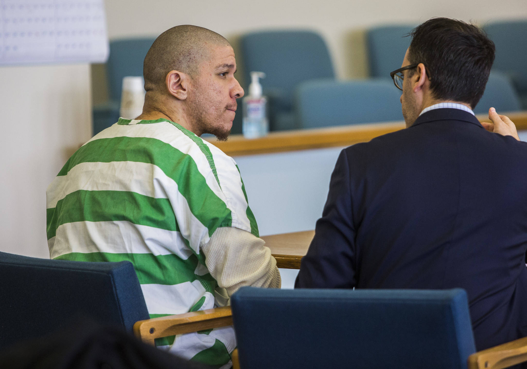 Matthew McGowan listens to his attorney before the start of a motion for a new trial at the Snohomish County Courthouse on Jan. 30 in Everett. (Olivia Vanni / Herald file)