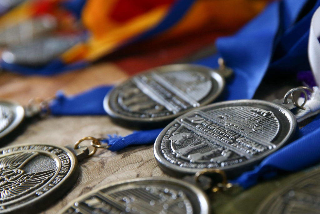 Ken Johnson’s vast collection of placement medals in various sports including archery, swimming and track. (Kevin Clark / The Herald)
