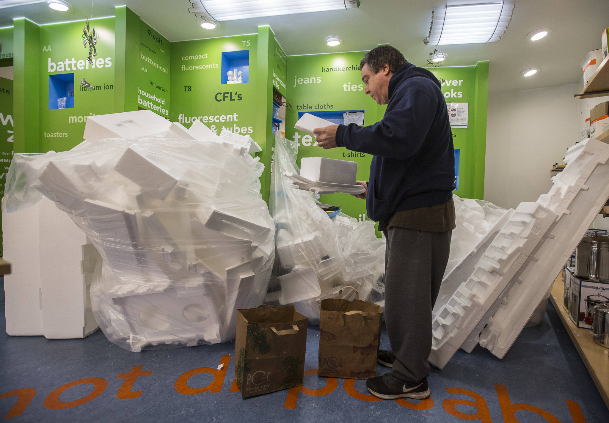 Matthew Ortiz recycles some of his styrofoam at the Recology store in Bothell. (Olivia Vanni / The Herald)