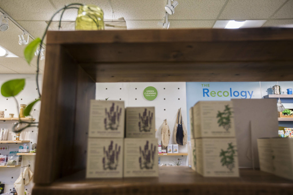 Environmentally friendly products and mottos line the shelves and walls of the Recology store in Bothell. (Olivia Vanni / The Herald)
