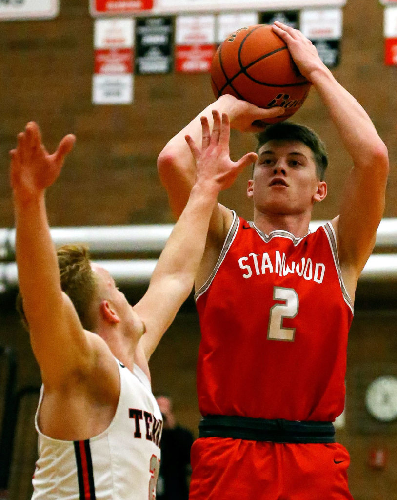 Stanwood’s Jake Cleary attempts a 3-pointer with Mountlake Terrace’s Bradey Blackmer defending at Mountlake Terrace High School on Jan. 10. (Kevin Clark / The Herald)

