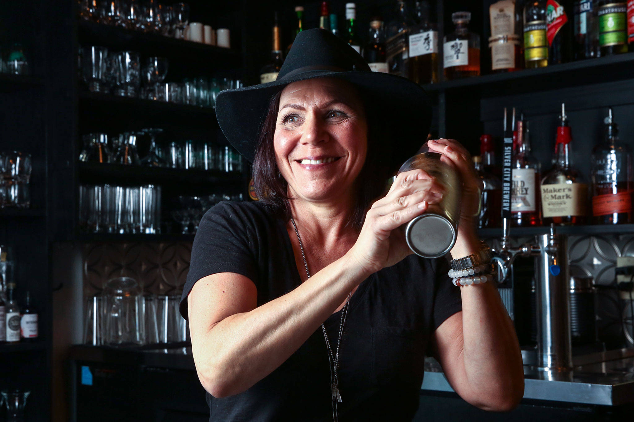 Traci McFarlane, owner of Bits in Mukilteo, not only mixes drinks but cooks all the dishes on the place’s small-plates menu. (Kevin Clark / The Herald)