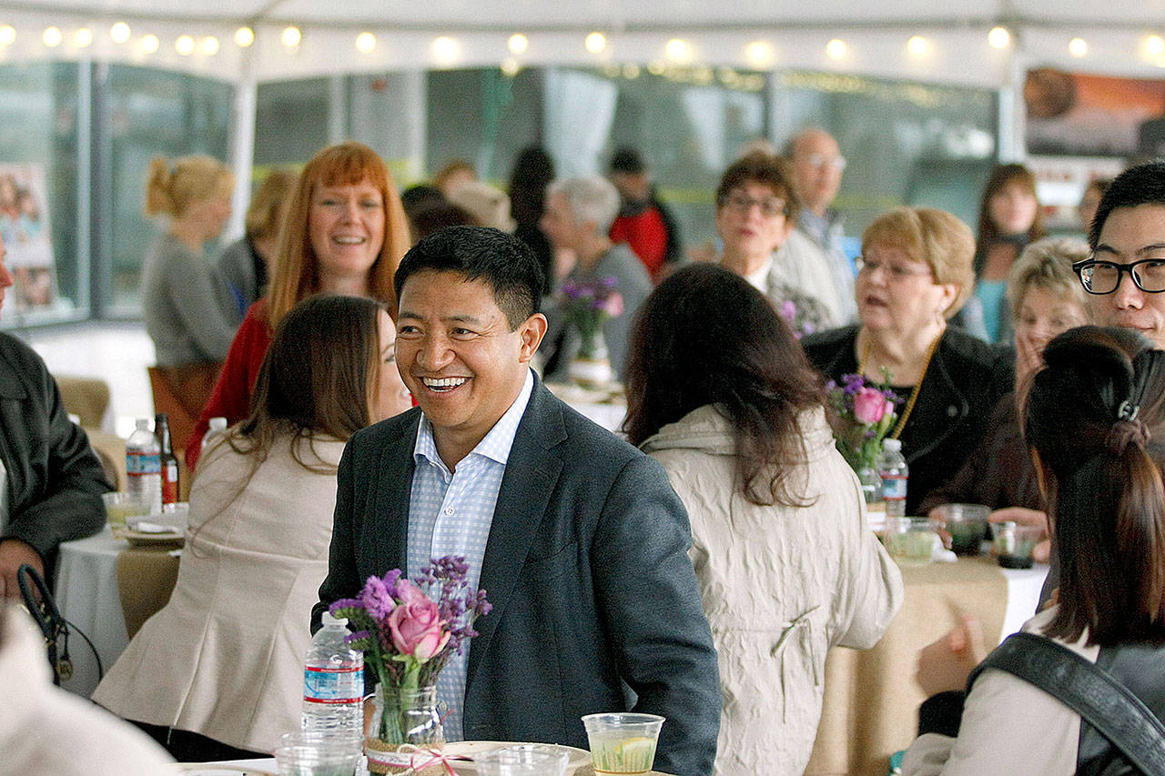 Lobsang Dargey (center) attends a sneak peak event at Potala Place Everett on April 30, 2015. (Ian Terry / Herald file)