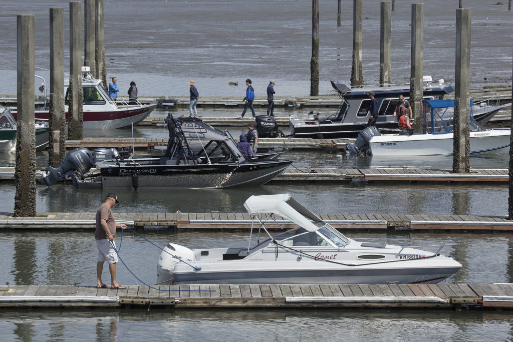 Boaters launch and retrieve their vessels July 19 during the fishing and shellfish season at the Jetty Landing and Boat Launch in Everett. (Andy Bronson / Herald file)
