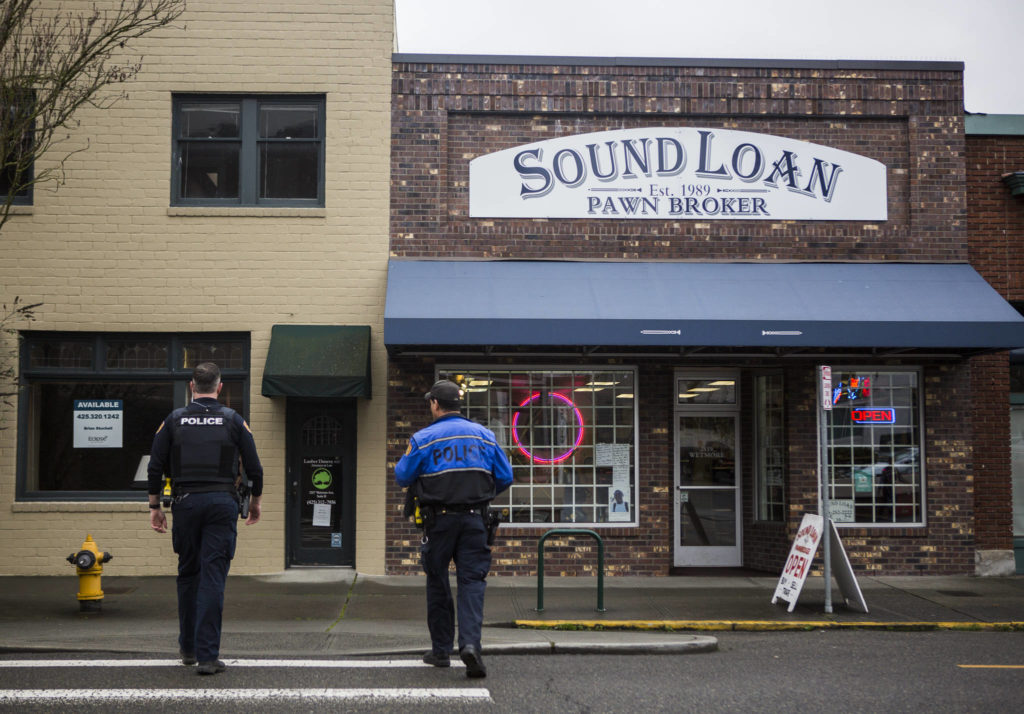 Everett Police Officers Kevin Davis (left) and Mike Bernardi cross Wetmore Avenue on Thursday. (Olivia Vanni / The Herald)
