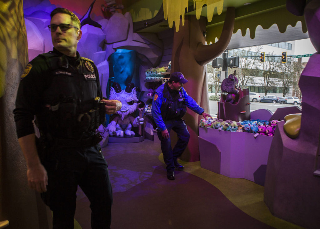 Everett Police Officers Kevin Davis (left) and Mike Bernardi stop by Funko on Thursday during a walking patrol of downtown. (Olivia Vanni / The Herald)
