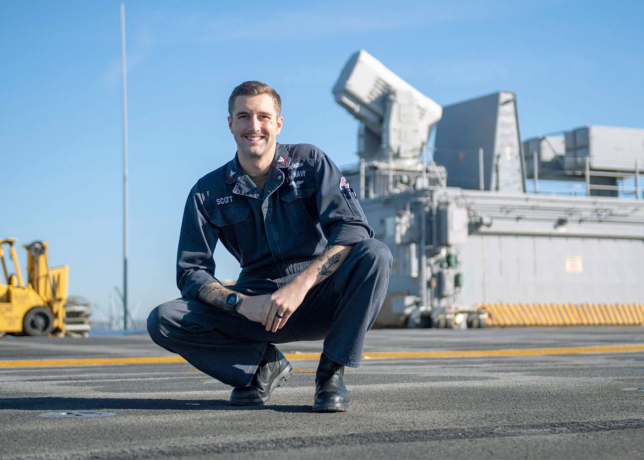 Photo by Mass Communication Specialist 1st Class Tim Miller                                 Petty Officer 2nd Class Tucker Scott.