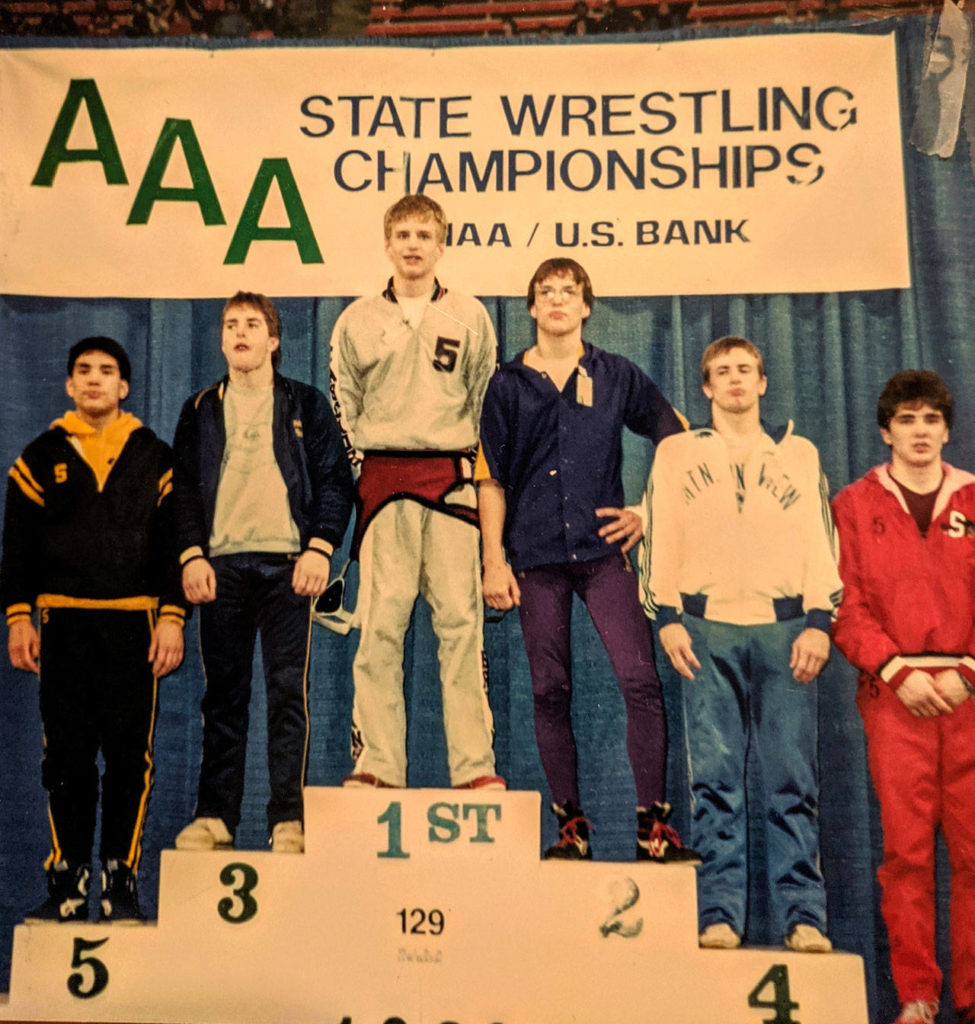 Chris Borsheim of Cascade (5) stands atop the podium at Mat Classic 1 in 1989 after winning the Class AAA state title at 129 pounds. (Photo courtesy Chris Borsheim)

