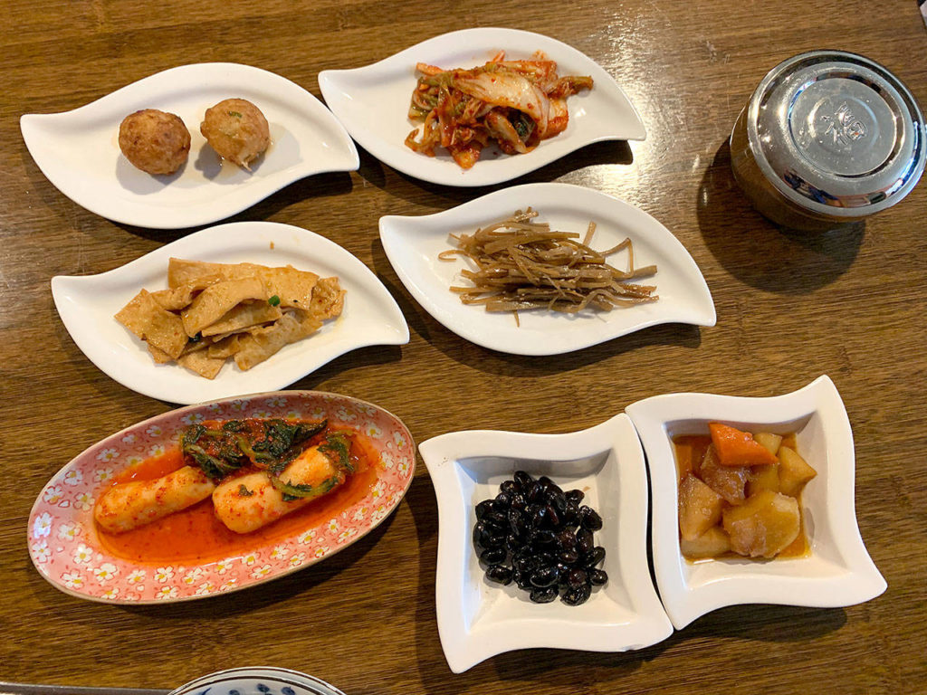 Meals at Modoo start with appetizers: takoyaki, fish cakes and radish. (Evan Thompson / The Herald)
