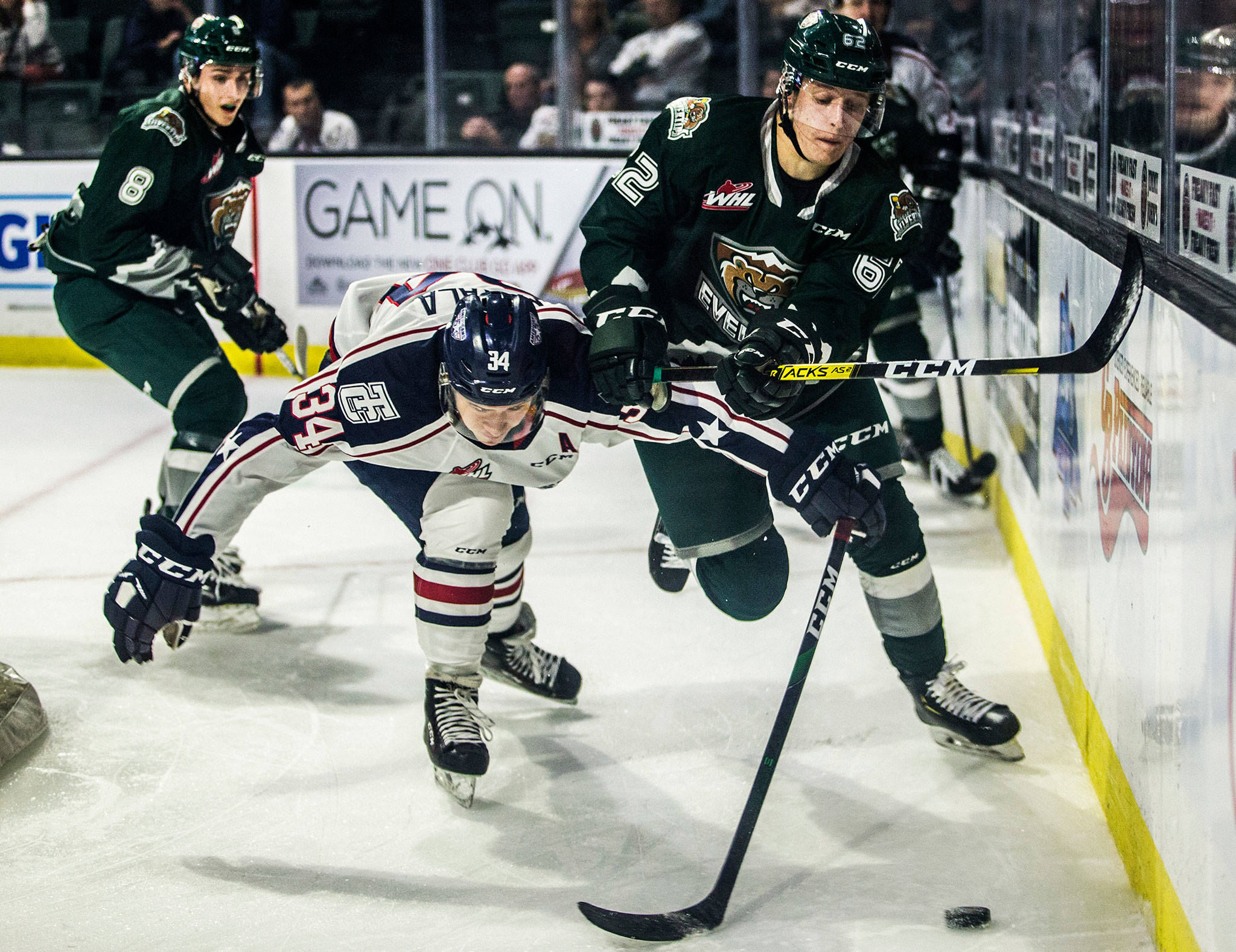 The Silvertips’ Michal Gut (right) fights the Americans’ Sasha Mutala for the puck during a game on Sept. 20, 2019, in Everett. (Olivia Vanni / The Herald)