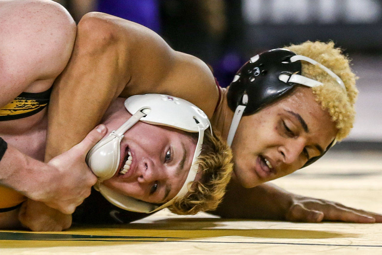 Marysville Pilchuck’s Cayden White (left) struggles against Bethel’s Josh Walker during the 3A state championship bout at 170 pounds during Mat Classic XXXI on Feb. 15, 2019 in the Tacoma Dome. (Kevin Clark / The Herald)