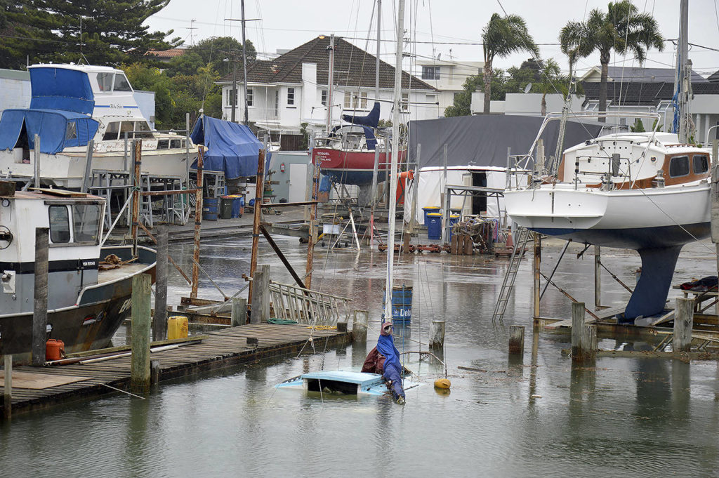 This 2018 photo shows boats sit swamped by flooding from a king tide in Milford Marina, Auckland, New Zealand. (Ben Sheeran/King Tides Auckland via AP)
