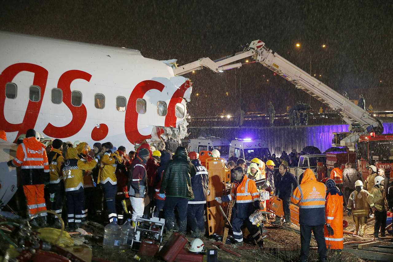 Rescue members and firefighters work after a plane skidded off the runway at Istanbul’s Sabiha Gokcen Airport, in Istanbul on Wednesday. (AP Photo/Emrah Gurel)