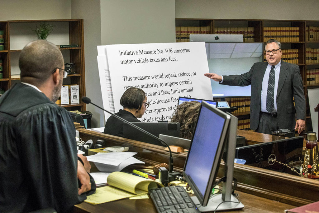 Attorney David Hackett speaks to Judge Marshall Ferguson in King County Court on Friday in Seattle, during the car-tab initiative 976 hearing which the city and others are suing to stop. (Steve Ringman/The Seattle Times via AP)
