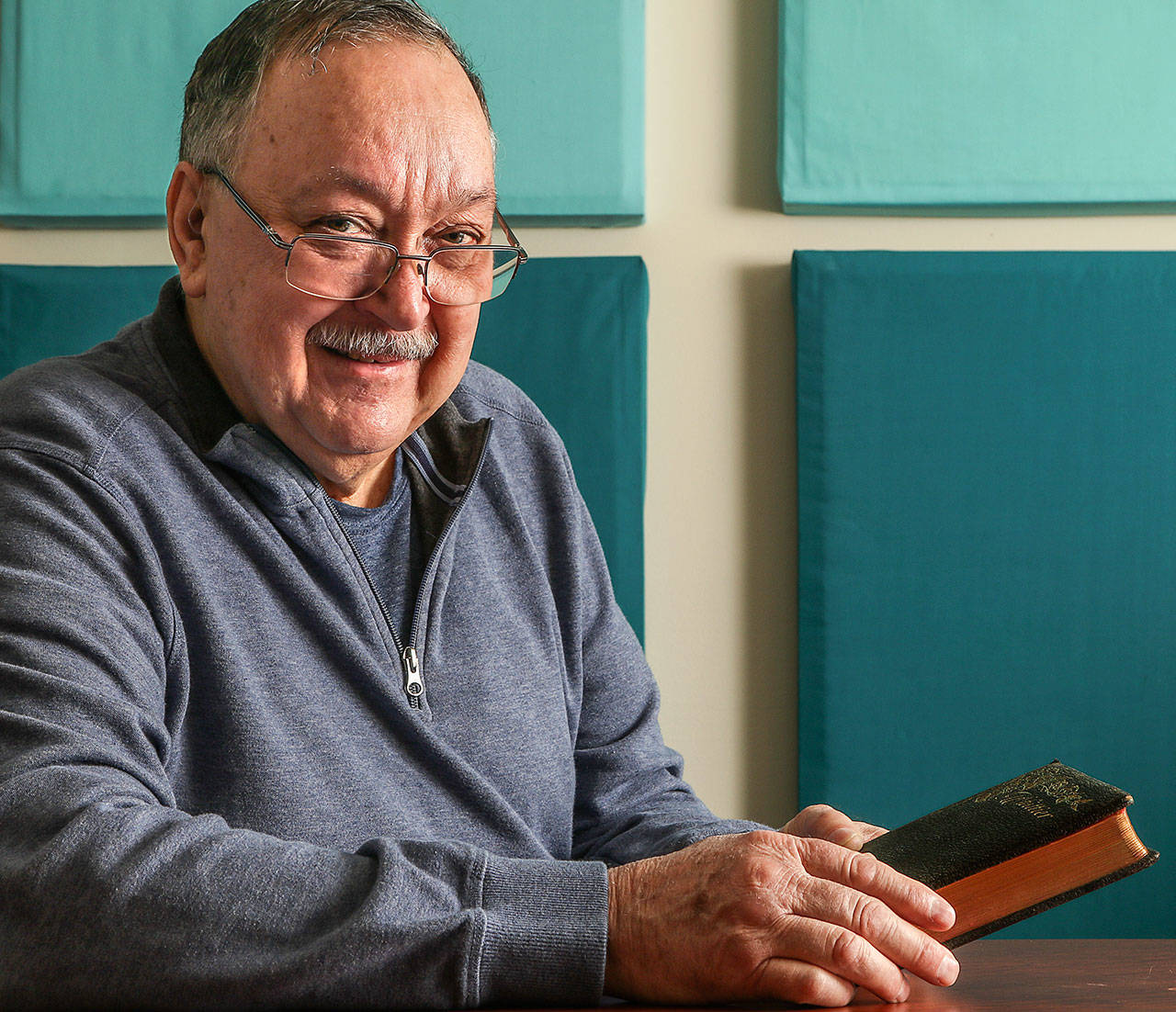 Marysville’s Phil Jubie holds a book of poetry by John Greenleaf Whittier that once belonged to his great-uncle, Edwin Ritchie. Jubie would love to know the story behind the book’s inscription, from someone named Lulu. (Dan Bates / The Herald)