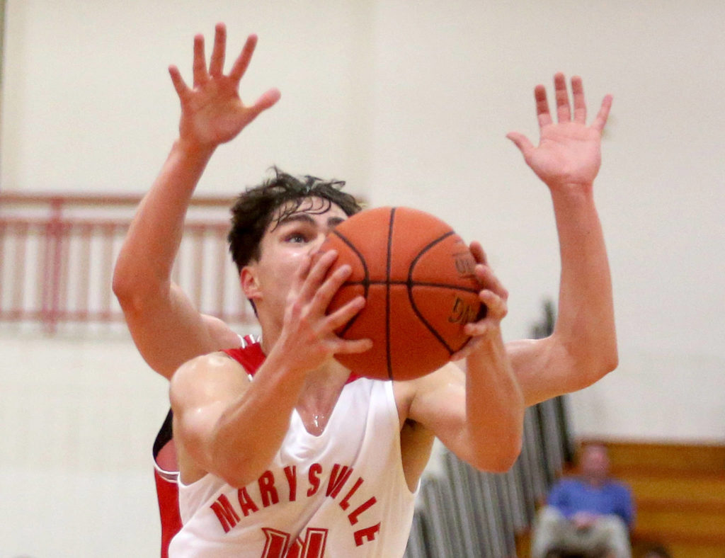 Marysville-Pilchuck’s Brady Phelps appears to have more than enough hands to score a basket as Marysville Pilchuck beat Stanwood 76-31 in a basketball game Monday, Feb. 10, 2020 in Marysville. (Andy Bronson / The Herald)
