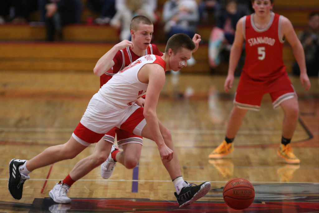 Marysville Pilchuck’s Luke Dobler and Stanwood’s Cort Roberson chase a loose ball as Marysville Pilchuck beat Stanwood 76-31 in a basketball game on Monday, Feb. 10, 2020 in Marysville. (Andy Bronson / The Herald)
