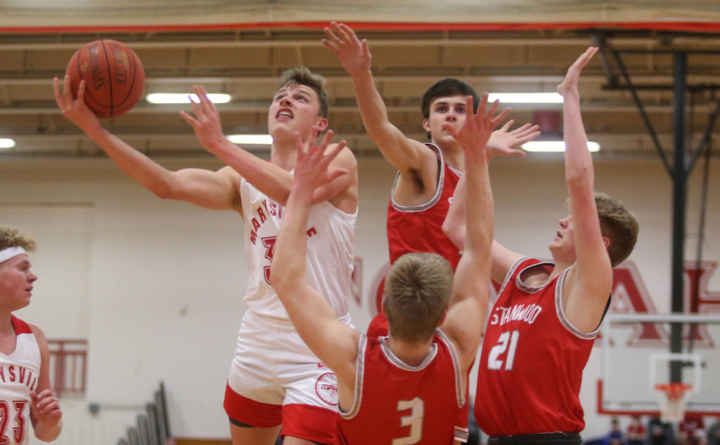 Marysville Pilchuck’s Aaron Kalab attempts a layup around three Stanwood defenders as Marysville Pilchuck beat Stanwood 76-31 in a game Monday, Feb. 10, 2020 in Marysville. (Andy Bronson / The Herald)
