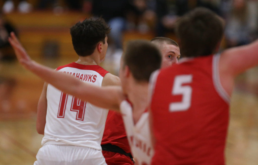 Stanwood’s Cort Roberson looks for an open teammate to pass the ball to as Marysville-Pilchuck beat Stanwood 76-31 in a basketball game Monday, Feb. 10, 2020 in Marysville. (Andy Bronson / The Herald)
