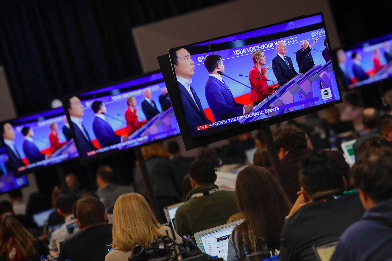 Members of the media watch the broadcast of the Democratic presidential primary debate, Feb. 7, at Saint Anselm College in Manchester, N.H. (Charles Krupa / Associated Press)