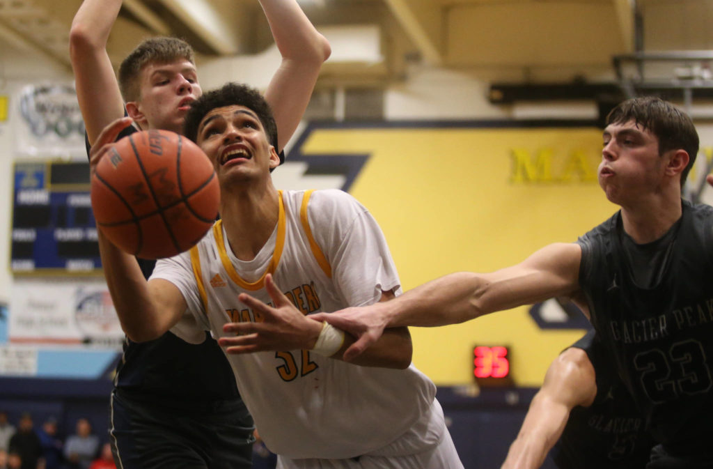Mariner’s Henry Avra is fouled by Glacier Peak’s Brayden Quantrille while going up for a basket. Mariner lost to Glacier Peak 90-87 in double overtime in a boys basketball game on Tuesday, Feb. 11, 2020 in Everett. (Andy Bronson / The Herald)

