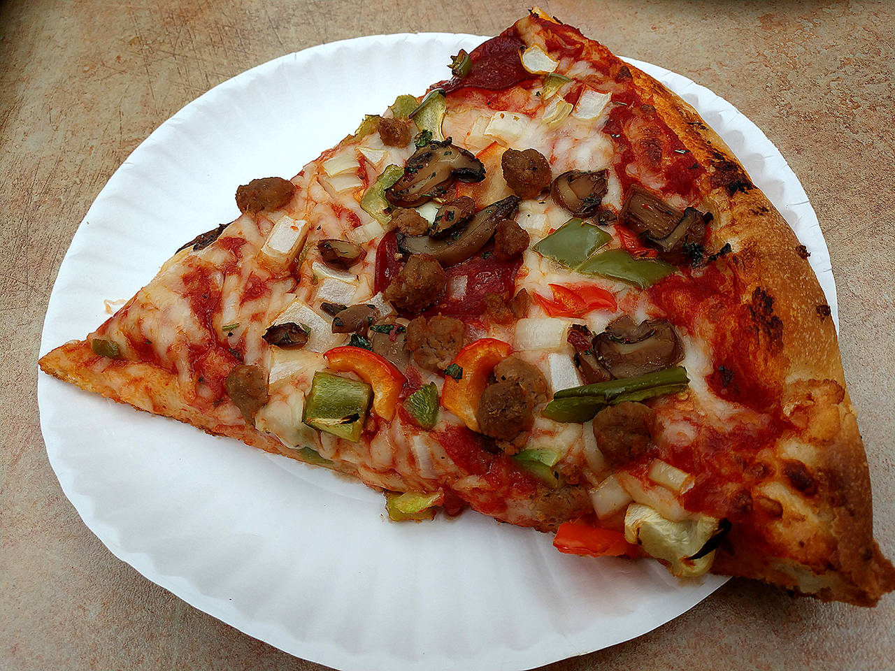 Mo’s supreme pizza is topped with pepperoni, sausage, bell pepper, onion and mushrooms. (Sara Bruestle / The Herald)