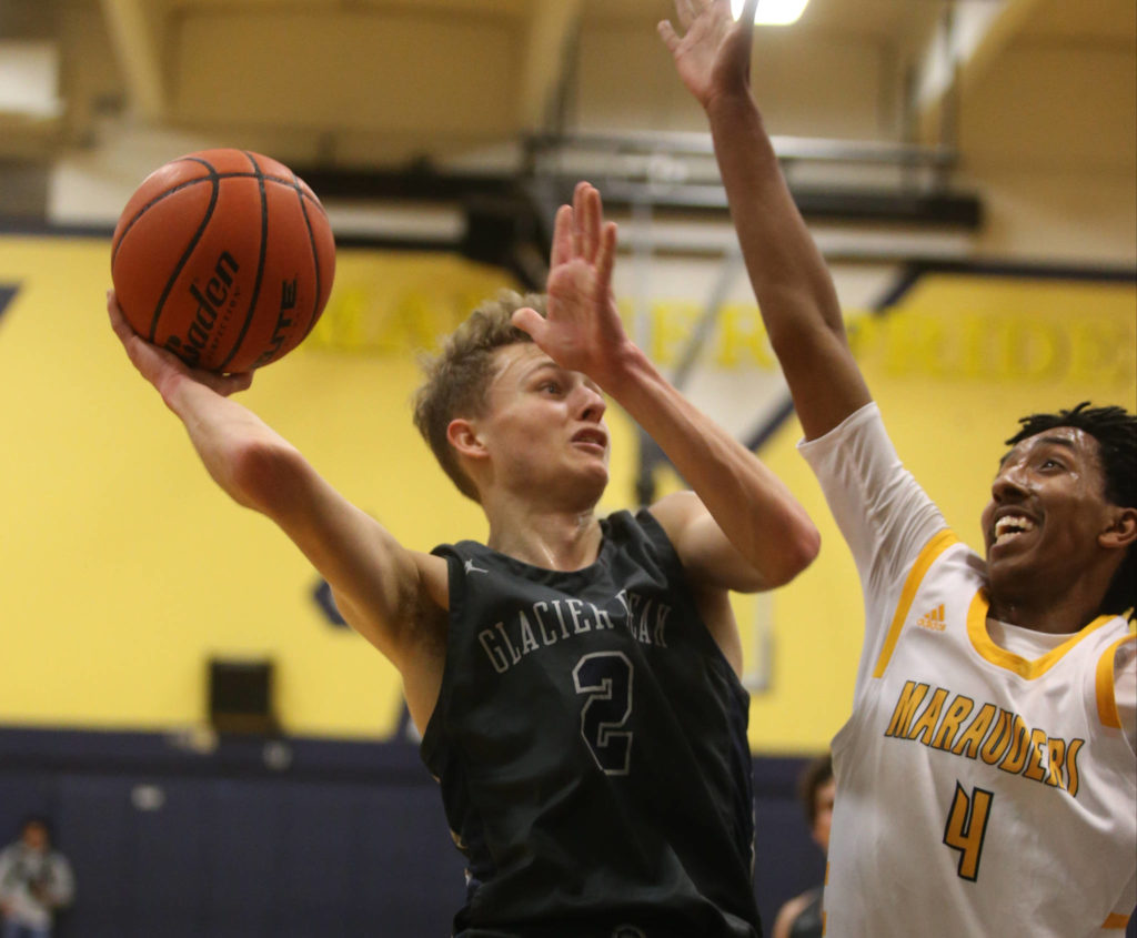 Glacier Peakճ Caleb Lee tries a layup defended by Mariner’s Simon Fanuel. Mariner lost to Glacier Peak 90-87 in double overtime in a boys’ basketball game on Tuesday, Feb. 11, 2020 in Everett, Wash. (Andy Bronson / The Herald)
