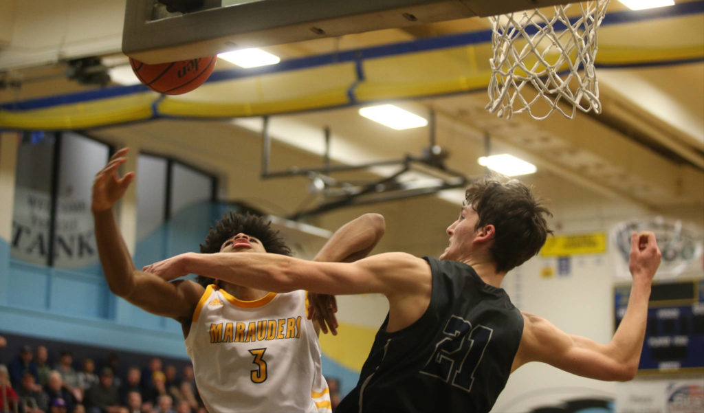 Mariner’s Jailin Johnson is fouled by Glacier Peakճ Pierce Darlington as Mariner lost to Glacier Peak 90-87 in double overtime in a boys’ basketball game on Tuesday, Feb. 11, 2020 in Everett, Wash. (Andy Bronson / The Herald)
