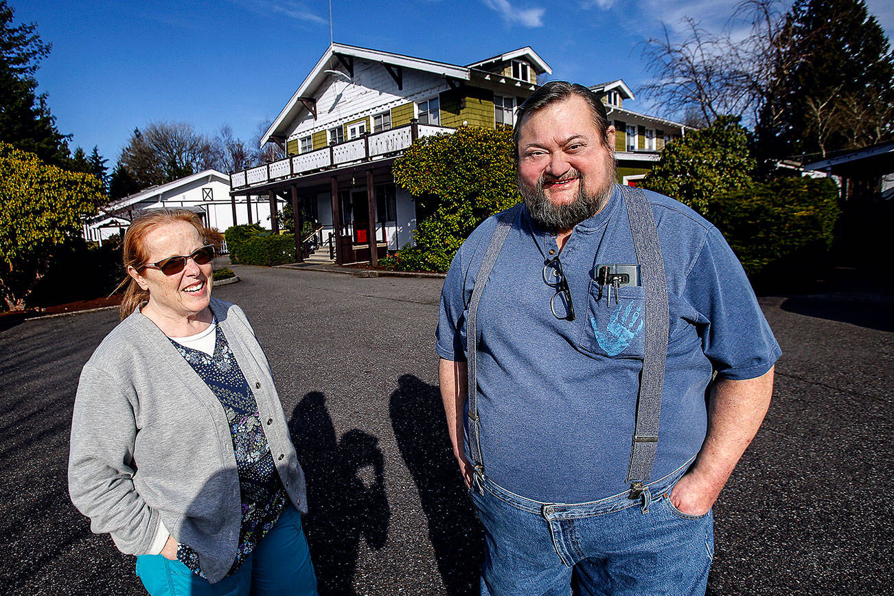 Chris Walsh and his wife, Carol, talk outside the Delta Rehabilitation Center about their plans to close the care facility long known as the Snohomish Chalet. Chris is the owner and administrator of the nursing home that cares for people with severe brain injuries. Carol has worked as a nurse there for many years. (Dan Bates / The Herald)