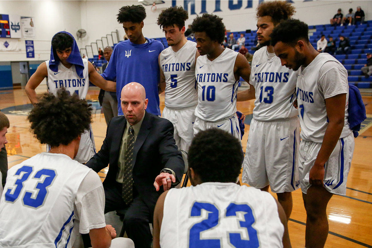 Edmonds Community College men’s basketball coach Kyle Gray leads a time out during the Tritons’ 88-76 victory over Olympic on Wednesday at Seaview Gym. (Kevin Clark / The Herald)