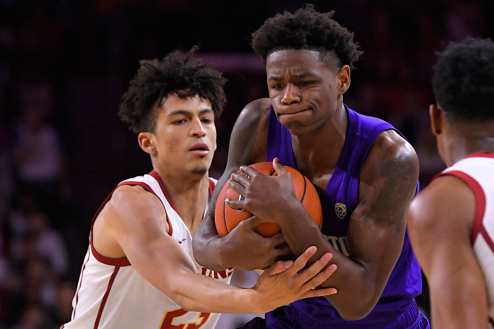 USC forward Max Agbonkpolo (left) ties up Washington guard Nahziah Carter during the first half of a game Thursday in Los Angeles. (AP Photo/Mark J. Terrill)