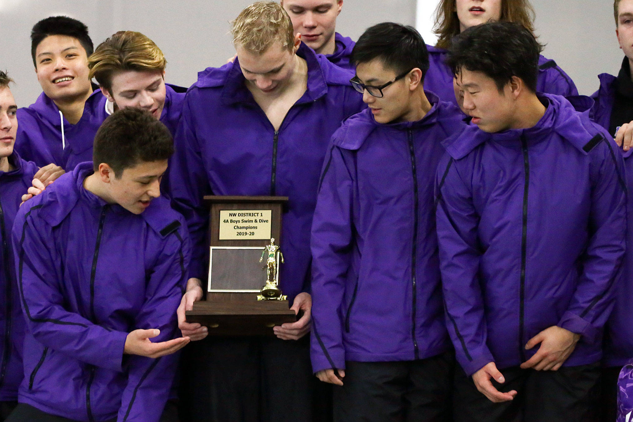 Kamiak swimmers pose with the team championship trophy at the end of the 4A Northwest District swim and dive finals Saturday at Snohomish Aquatic Center in Snohomish. Kamiak won its 11th team title in 13 years. (Kevin Clark / The Herald)