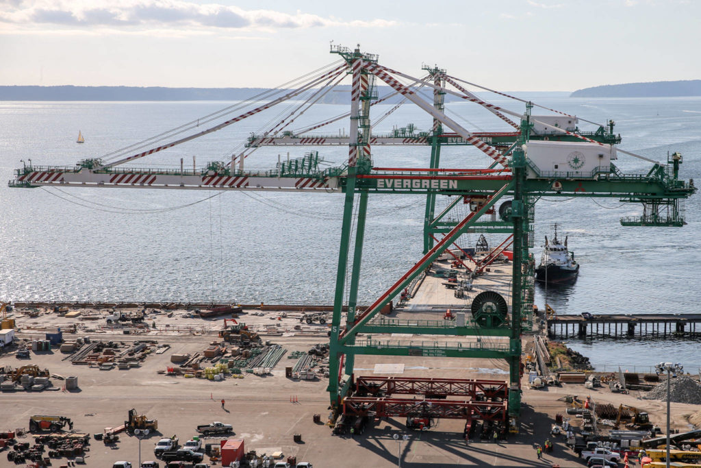 One of the 214-foot cranes is off-loaded June 14, 2019, at the Port of Everett South Terminal. It and its twin will keep their orange and white striped painting, as required by the Federal Aviation Administration. (Kevin Clark / Herald file)
One of the 214-foot port cranes is off loaded at the South Terminal at the Port of Everett Friday afternoon on June 14, 2019. (Kevin Clark / Herald file)
