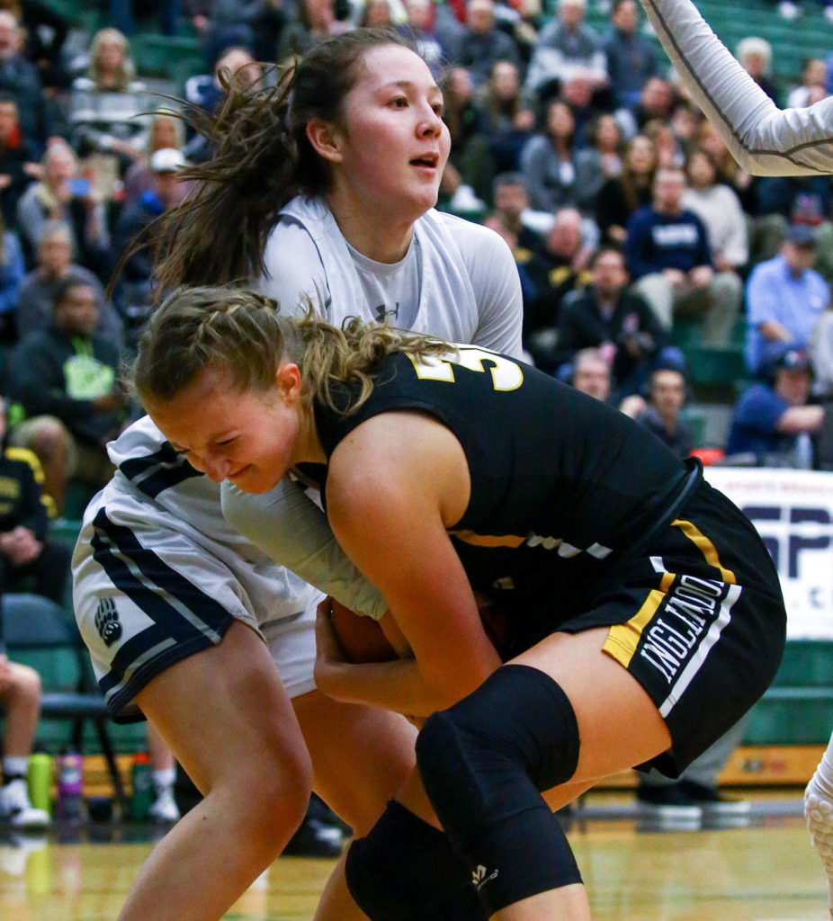 Glacier Peak’s Maya Erling (rear) ties up with Inglemoor’s Abby Haller during a Wes-King Bi-District Tourmament game on Tuesday evening at Jackson High School in Mill Creek. (Kevin Clark / The Herald)
