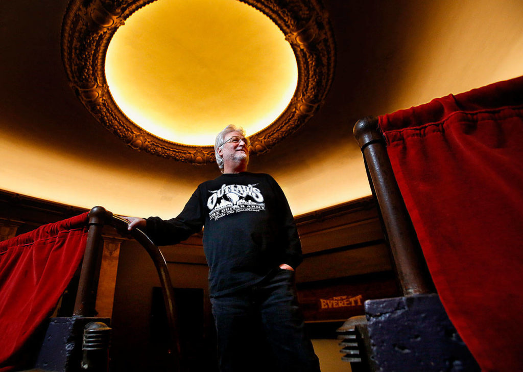 Curt Shriner looks out from behind the balcony rail in the Historic Everett Theatre, which he has managed since 2014. His brother, Curt Shriner, owns the building. (Dan Bates / Herald file)
