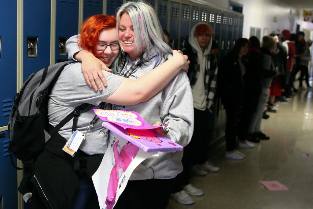 A student hugs Tracy Orr goodbye Thursday morning at Crossroads High School in Granite Falls. (Kevin Clark / The Herald)
