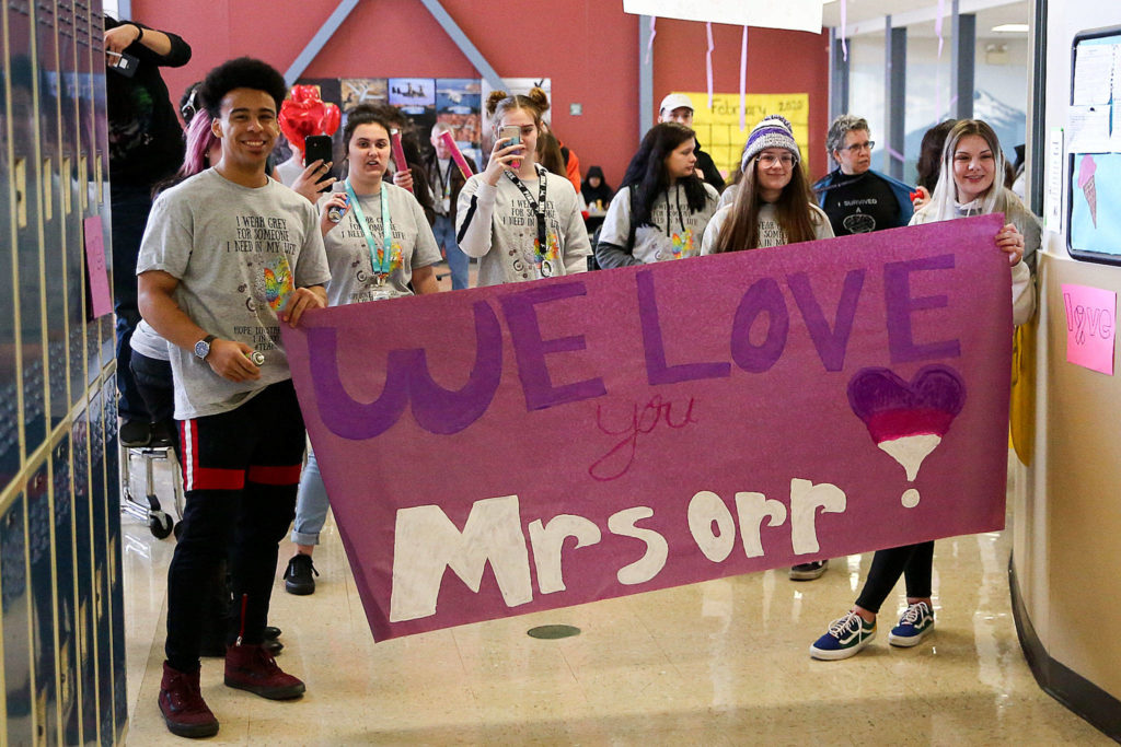 Crossroads High School students honor Tracy Orr on Thursday as she gets ready to go on leave for surgery to remove a brain tumor. (Kevin Clark / The Herald)
