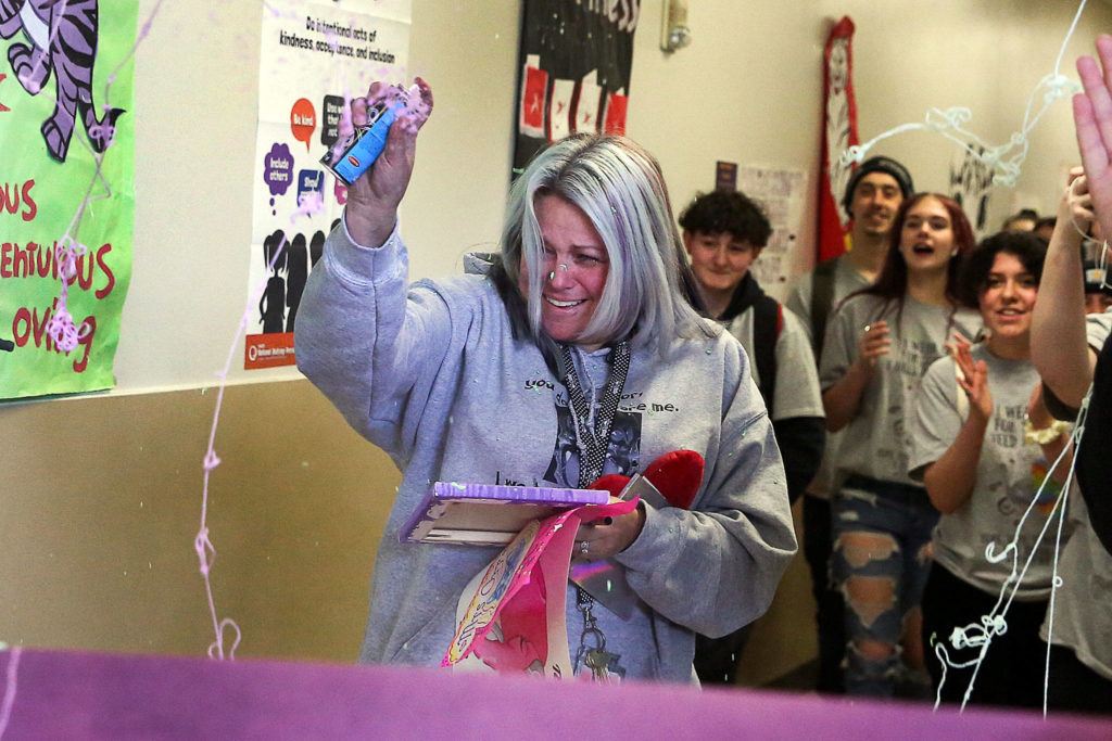 Tracy Orr gets in a Silly String fight during her going-away party Thursday at Crossroads High School in Granite Falls. (Kevin Clark / The Herald)
