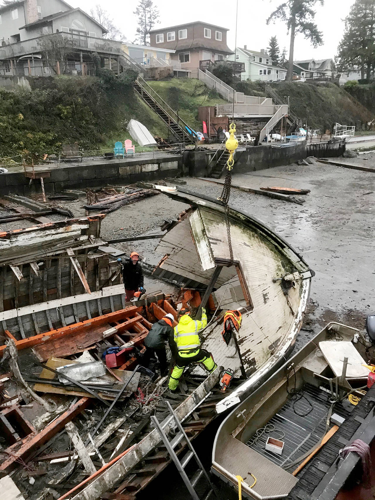 Workers break up the Argosy in January after it washed ashore at Warm Beach. It’s now in pieces in Seattle. (Global Diving & Salvage)