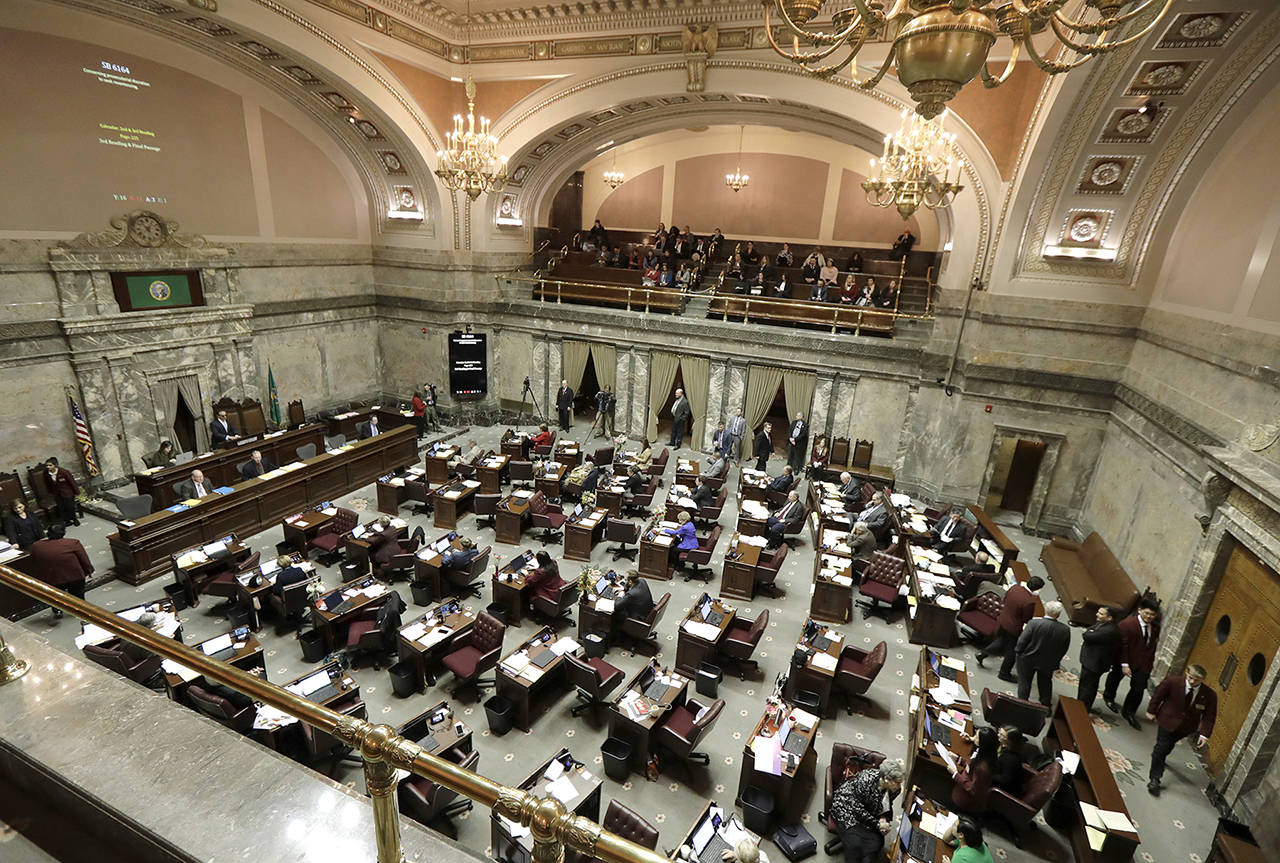 Lawmakers work on the Senate floor Wednesday at the Capitol in Olympia. (Ted S. Warren / Associated Press)