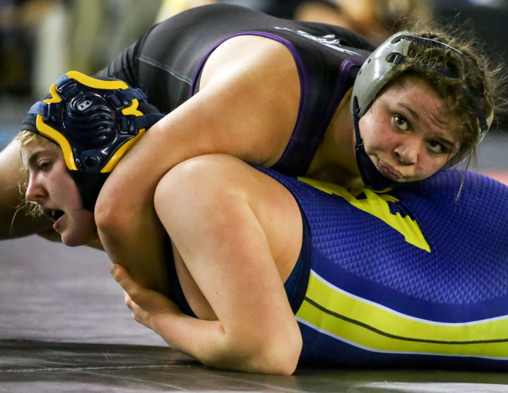 Lake Stevens’ Kiley Hubby looks to the clock while wrestling Katie Gakin of Aberdeen in a girls 170-pound match on Day 1 of Mat Classic XXXII Friday at the Tacoma Dome. (Kevin Clark / The Herald)
