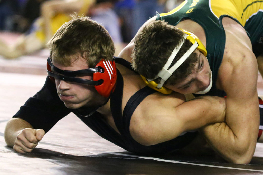 Darrington’s Lucas Reuwsaat (right) wrestles Cole Prince of Liberty in a 1B/2B 160-pound match on Day 1 of Mat Classic XXXII Friday at the Tacoma Dome. (Kevin Clark / The Herald)
