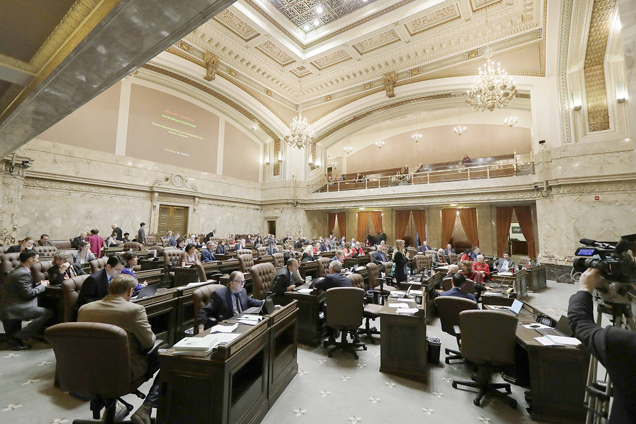 Lawmakers work on the House floor Feb. 19 at the Capitol in Olympia. (AP Photo/Ted S. Warren)