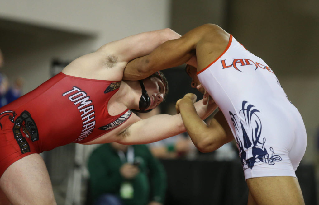 Marysville Pilchuck’s Cayden White (left) tries to get control over Lakes’ Jaedon Hall in their 3A 182-pound championship match during Mat Classic XXXII on Saturday at the Tacoma Dome. White won 5-1. (Andy Bronson / The Herald)
