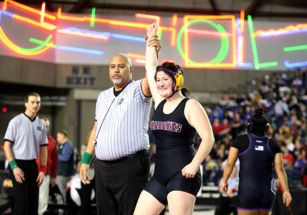 Marysville Pilchuck’s Alivia White is all smiles as her arm is raised after pinning Connell’s Rosa Saucedo-Ramirez in their girls 190-pound championship match during Mat Classic XXXII on Saturday at the Tacoma Dome. (Andy Bronson / The Herald)
