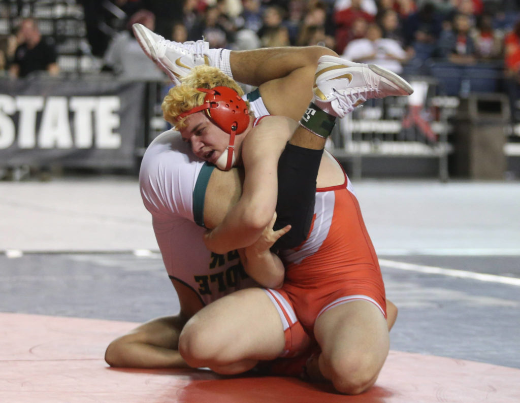 Stanwood’s Riley Van Scoy tries to take down Shadle Park’s Juan Escobar during their 3A 170-pound championship match at Mat Classic XXXII on Saturday at the Tacoma Dome. (Andy Bronson / The Herald)
