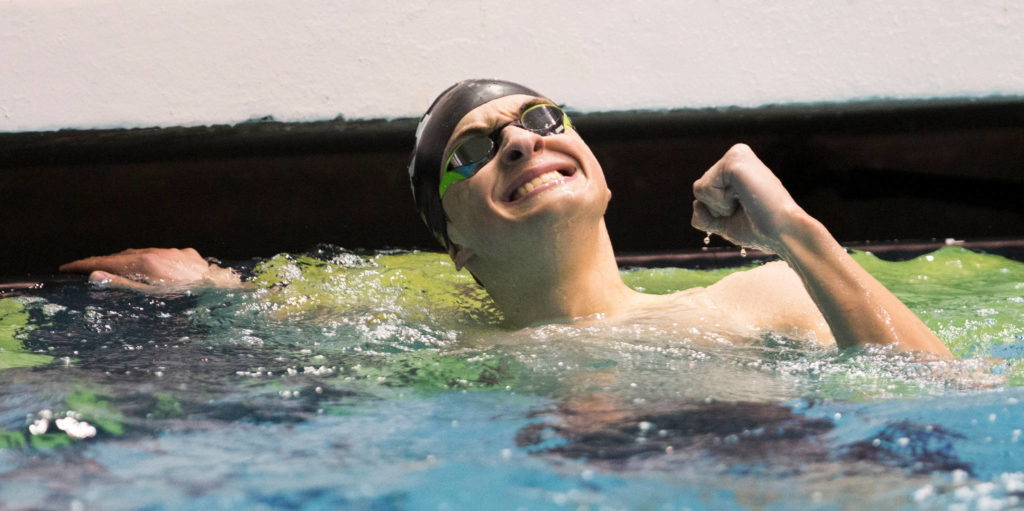 Lake Stevens’ Alejando Flores reacts after coming in third in the 100 butterfly at the 4A state swim and dive championships on Saturday at the Federal Way Aquatic Center. (Andy Bronson / The Herald)
