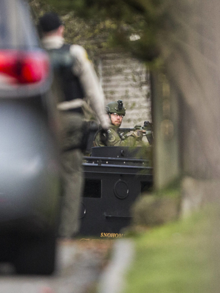 A police officer sits in an armored van with a gun on Sunday near Lynnwood. (Olivia Vanni / The Herald)
