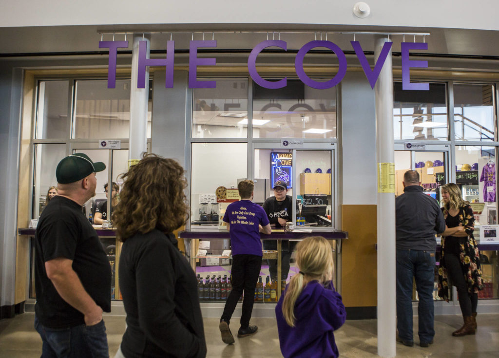 People walk by The Cove, a student store, during the Lake Stevens High School open house on Thursday. (Olivia Vanni / The Herald)
