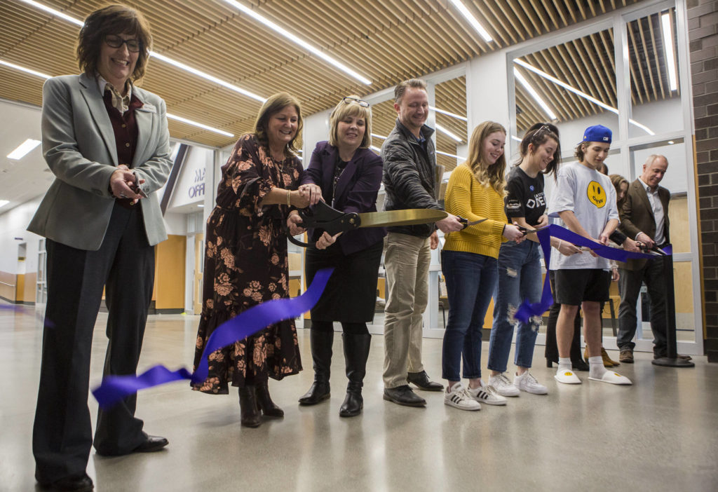 School leaders, students and faculty cut a ribbon durign an opening ceremony at Lake Stevens High School on Thursday. (Olivia Vanni / The Herald)

